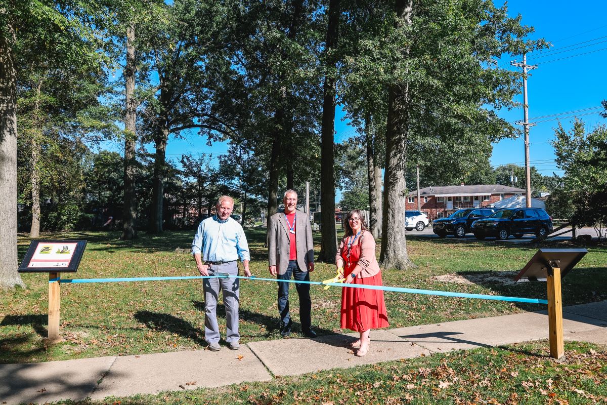 Cuyahoga Falls Mayor Walters, Library Director Andrew Harant, Children's Manager Amy Galluch perform a ribbon cutting on the new Cuyahoga Falls StoryWalk.