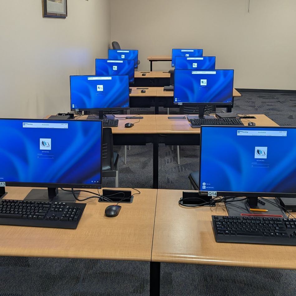 Rows of computers on tables.