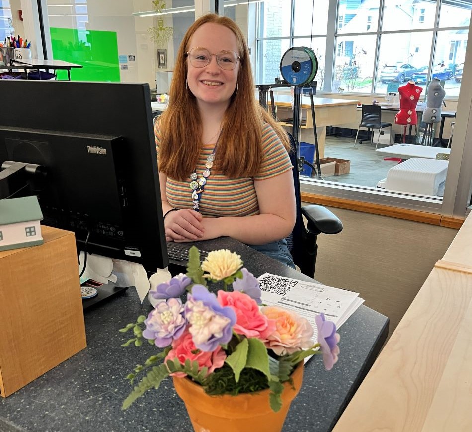 Librarian smiling at the Information Desk