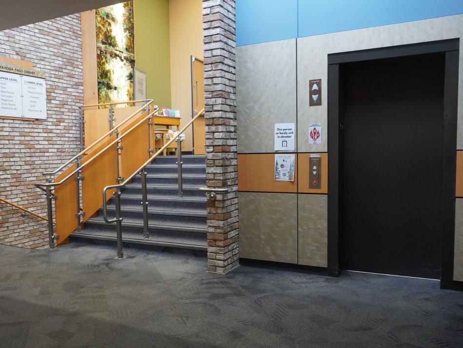 Library stairs going up and elevator doors.