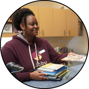 Library clerk handing a patron a book