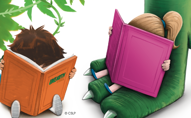 A boy and a girl each with their faces in their books girl is sitting on top of a large dinosaur foot.